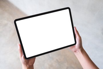 Top view mockup image of a woman holding digital tablet with blank white desktop screen