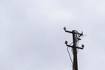cables and unused insulators on old and rusty lamppost