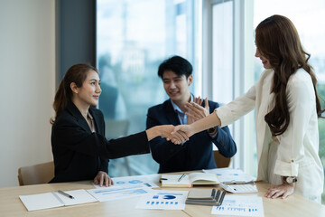 Fototapeta na wymiar Business asian people shaking hands, finishing up meeting, business etiquette, congratulation, merger and acquisition concept