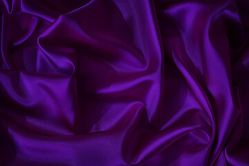 Deep purple violet silk satin. Shiny fabric. Wavy folds. Beautiful elegant background for design.