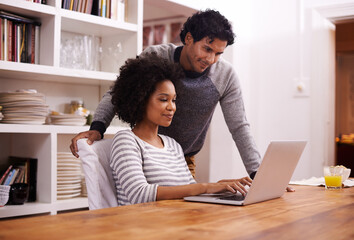 Your blog is looking great honey. Shot of a young couple using a laptop together at home.
