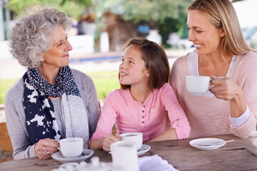 Bonding time for the girl. Shot of three generations of the woman of the women of a family having tea outside.