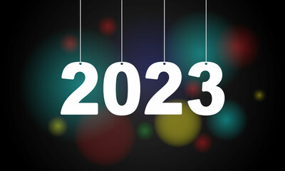Happy New Year 2023. Hanging  numbers with ribbons and confetti on a defocused colorful, bokeh background.