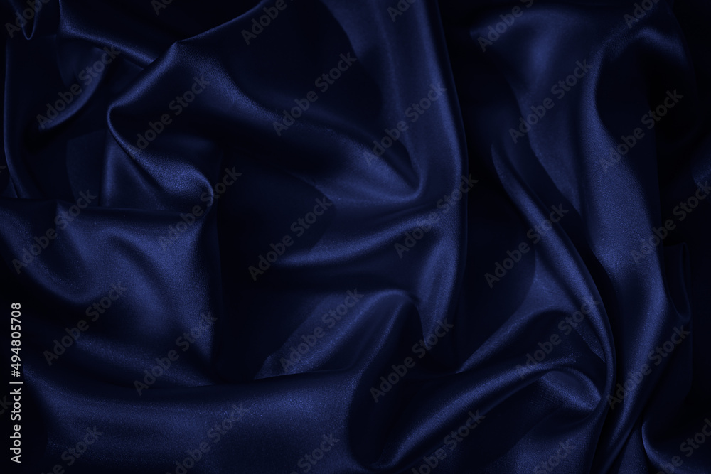 Wall mural navy blue silk satin. beautiful wavy folds. dark elegant background with space for design. the surfa