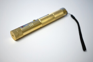 A hand-held laser pointer on a white isolate. Laser toy.