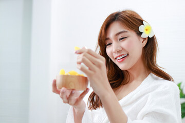 Beautiful Asian girl doing spa at home Holding a golden silk cocoon to scrub the face. Help nourish the skin to look young and healthy. beauty concept. copy space