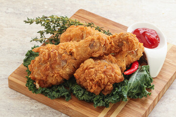 Fried chicken drumsticks with tomato sauce