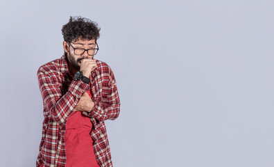 Young man coughing a lot ,man coughing on isolated background, man with pneumonia problem, concept of cough and throat problems
