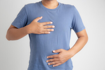 Man with acid reflux on white background, health care and diet concept.