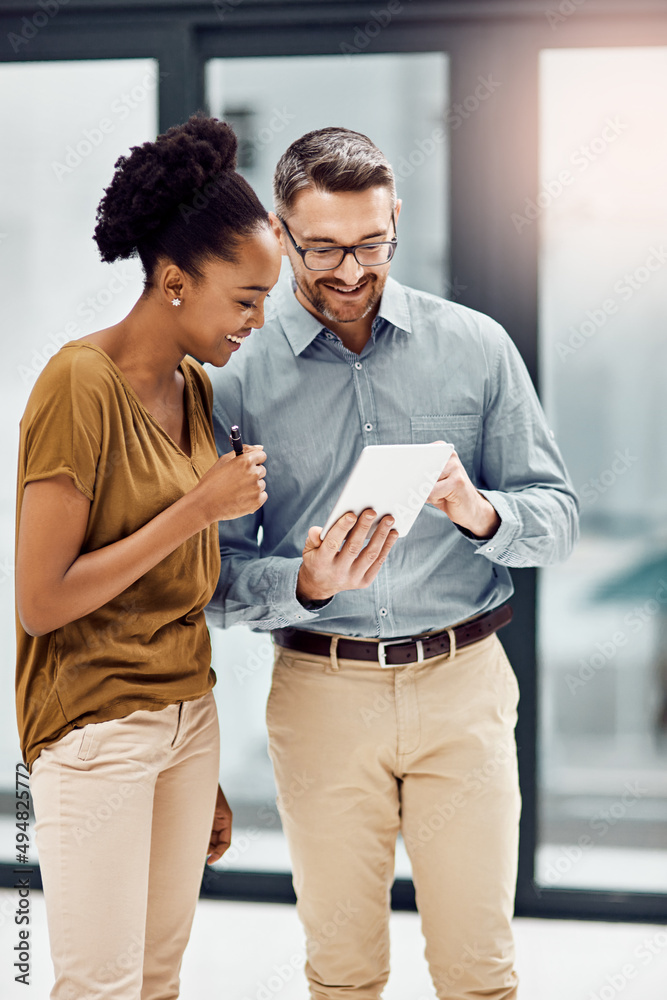 Poster could you take a look at something quick. cropped shot of two businesspeople looking at a digital ta