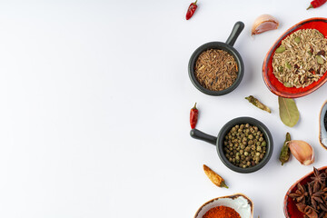 Bowls with various spices on white background