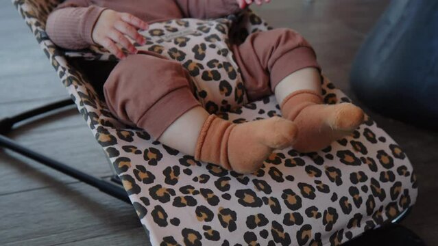 restless baby feet in rocking crib