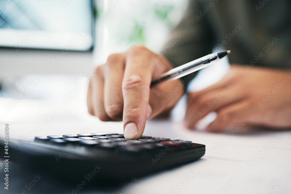 Aufkleber Let me calculate that. Shot of an unrecognizable businessperson using a calculator in an office.