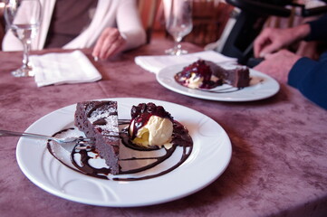 Closeup shot of chocolate cake with ice cream and fruits