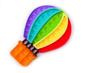 Rainbow colored bubble toy in the form of a balloon to relieve stress.