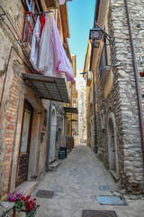 Fototapeta na wymiar A narrow street among the old stone houses of Taurasi, town in Avellino province, Italy.