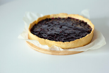 Sweet cake with black currant. Homemade pie with summer berries on a white table. side view from above. Tasty baked sweets. 