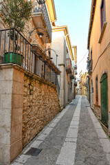 A narrow street among the old stone houses of Taurasi, town in Avellino province, Italy.