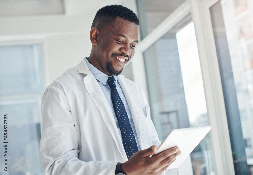 Poster i found the information i needed. shot of a young doctor using a digital tablet in an office.
