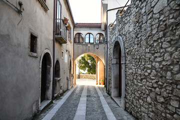 A narrow street among the old stone houses of Taurasi, town in Avellino province, Italy.