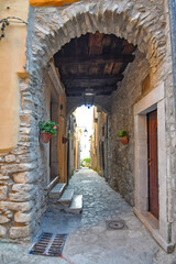 A narrow street among the old stone houses of Taurasi, town in Avellino province, Italy.