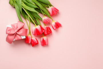 Beautiful spring surprise on Mothers or Womans International day 8 march. Bouquet of pink tulips, gift box on pink table top view. Flat lay, stylish banner for site, seasonal flyer - 494828167