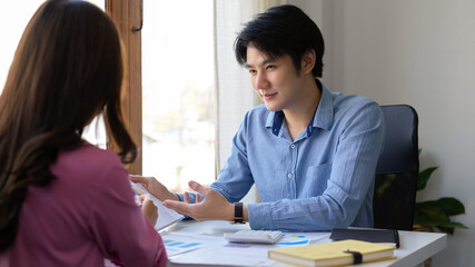 Male investment advisor or insurance agent having a meeting with female client