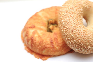 bagel, 2 donut shaped breads stacked on white background