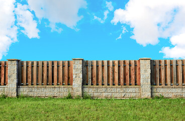 Brown wooden plank fence with block posts. House wall. Green grass lawn. Countryside private property. Minimalist landscape design. Rural real estate. Neighbors. Isolated mockup design. Exterior
