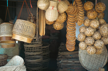 Eco-friendly wicker baskets and kratips (traditional rice containers) containers sold in a shop in...