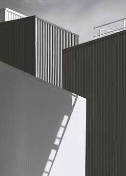 Black and white image of light and shadow on cold storage room surface with corrugated metal industrial buildings in perspective view and vertical frame 