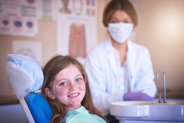 Now is the best time to start with dental care. Shot of a little girl at the dentist for a checkup.