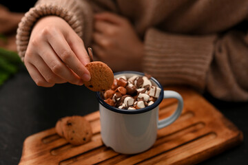 Close-up, Female dripping soft cookie into a hot chocolate