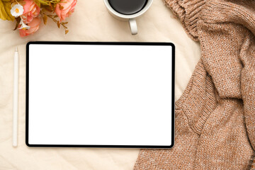Minimalist workspace with digital tablet on beige background. top view
