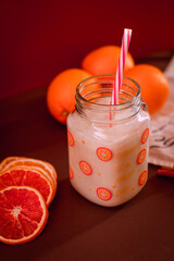 Milkshake with oranges on a red background