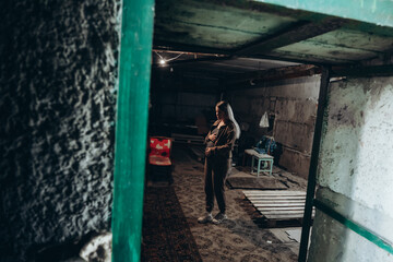Obraz na płótnie Canvas War in Ukraine. A Ukrainian pregnant woman hides in a bomb shelter while resisting a Russian invasion.