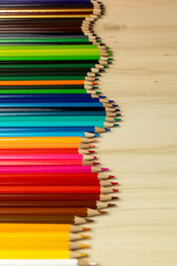Fototapeta premium Color pencils isolated on wood background.