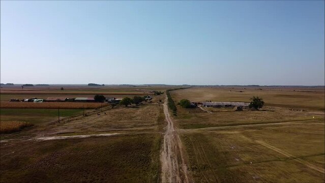 Drone flying backwards in the hungarian lowland, in the big plain, the "Puszta". No clouds. Clear sky. Free view. Simply beautiful.