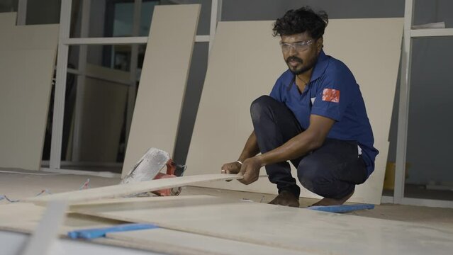aluminium worker marking wood for design and renovation work at construction site - concept of skilled ocupation, blue collar jobs and home or office improvement.