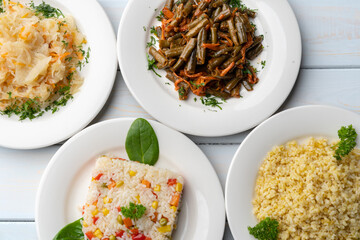 Variety of garnishes like cooked rice, bulgur, stewed cabbage and green beans