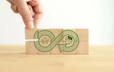 Green eco infinity, net zero, circular economy, renewable energy and save world concept. Sustainable development.  Hand puts wooden cubes with green econ infinity on white background. Eco banner.