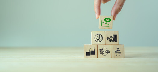 Low carbon emission and net zero concept. Climate changing problems solving goals. Stacking wooden...