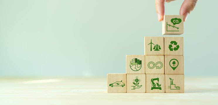 Low Carbon,carbon Neutral Concept. Net Zero Greenhouse Gas Emissions Target. Climate Neutral Long Term Strategy. Hand Put Wooden Cubes With Decrease Carbon Emission Icon And Green Icon. Green Banner.