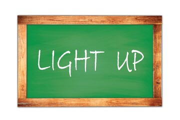 LIGHT  UP text written on green school board.
