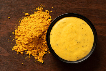 Curry sauce and curry powder on wood from above. - 494839165