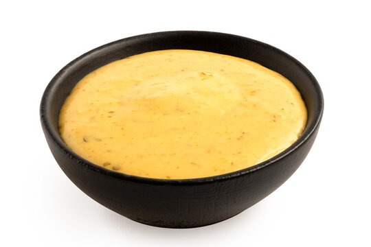 Curry sauce in a black bowl.