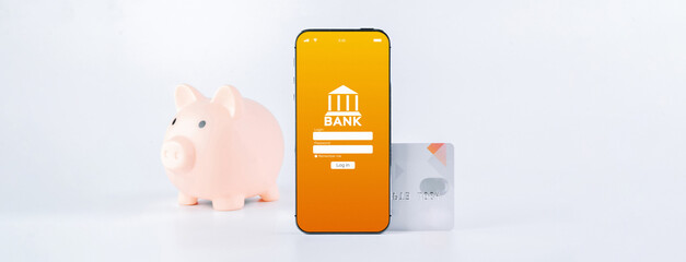 E banking concept. Mobile phone with internet online bank app. Pig bank with credit card on white background. Online wallet save money.