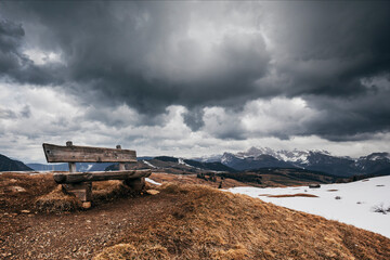 Naklejka premium landscape in the mountains with stormy sky and snow