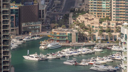 Fototapeta na wymiar Aerial view on yachts floating in harbor timelapse.