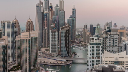 Obraz premium View of various skyscrapers in tallest recidential block in Dubai Marina aerial day to night timelapse